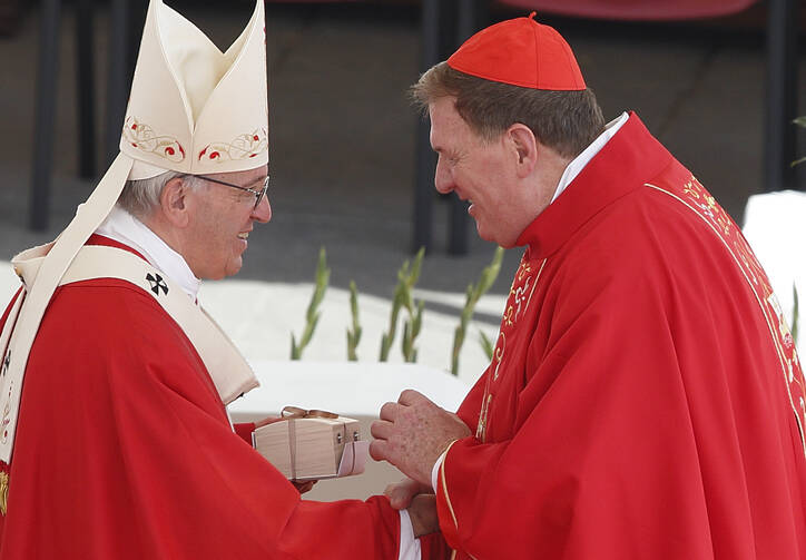 Pope Francis presents a box containing a pallium to Cardinal Joseph W. Tobin of Newark, N.J., at the conclusion of Mass marking the feast of Sts. Peter and Paul in St. Peter's Square at the Vatican on June 29. New archbishops from around the world received their palliums from the pope. The actual imposition of the pallium will take place in the archbishop's archdiocese. (CNS photo/Paul Haring)