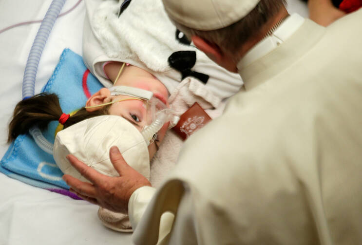 Pope Francis blesses a sick child in Paul VI hall at the Vatican Dec. 15, 2016, during a meeting with patients and workers of Rome's Bambino Gesu children's hospital. Responding to an Associated Press investigation, a top Vatican official said there had been past problems at the hospital, but that the current administration was making a "serious effort to resolve them." (CNS photo/Max Rossi, Reuters)