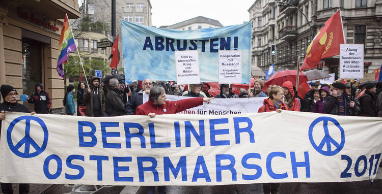 A group marching for nuclear disarmament carries a banner during a protest in mid-April in Berlin. Agencies of the U.S. and European Catholic bishops have called for all nations to develop a plan to eliminate nuclear weapons from their military arsenals. (CNS photo/Clemens Bilan, EPA) 