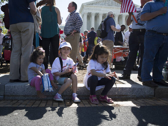 An immigration rally takes place April 18 outside the U.S. Supreme Court in Washington. The U.S. bishops' migration committee chair in a July 18 statement urged President Donald Trump to "ensure permanent protection" for youth under the Deferred Action for Childhood Arrivals program, or DACA. (CNS photo/Tyler Orsburn) 