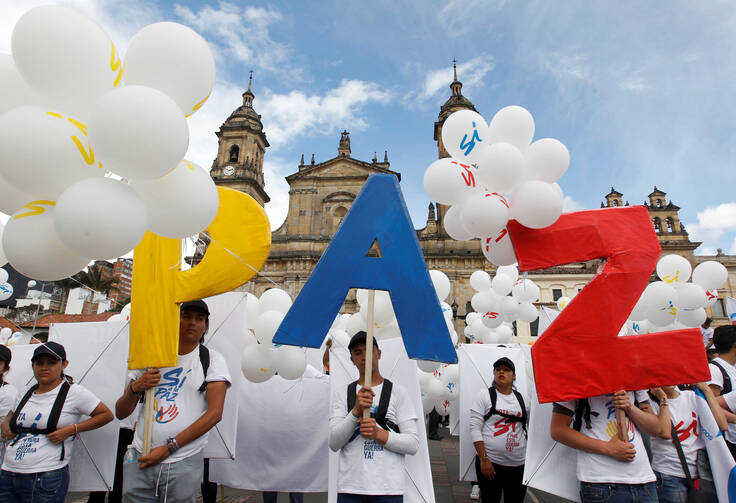 People outside the cathedral in Bogota chant "No more war" on Sept. 26, 2016, after the Colombian government and Marxist rebels signed an agreement to end their conflict. (CNS photo/Felipe Caicedo, Reuters)