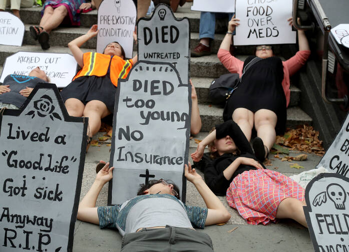 A demonstration for affordable health care in New York City on July 13. Bishop Frank J. Dewane of Venice, Fla., chairman of the U.S. bishops' Committee on Domestic Justice and Human Development, called on the Senate July 21 to fix problems with the Affordable Care Act in a more narrow way, rather than repeal it without an adequate replacement. (CNS photo/Andrew Gombert, EPA)