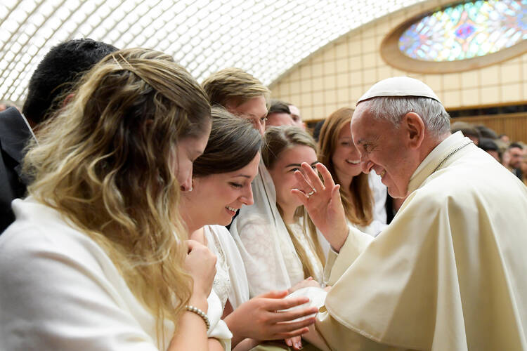 Pope Francis blesses a woman during his weekly audience in Paul VI hall at the Vatican Aug. 9 . (CNS photo/L'Osservatore Romano)
