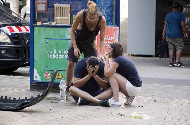 Injured people react after a van crashed into pedestrians in the Las Ramblas district of Barcelona, Spain, Aug. 17. Terrorists killed at least 12 and injured more than 50 others. (CNS photo/David Armengou, EPA) 