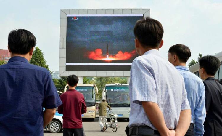 North Koreans watch a news report of an intermediate-range ballistic missile launch on a big screen at Pyongyang station in Pyongyang, North Korea, Aug. 30. (CNS photo/Kyodo via Reuters)