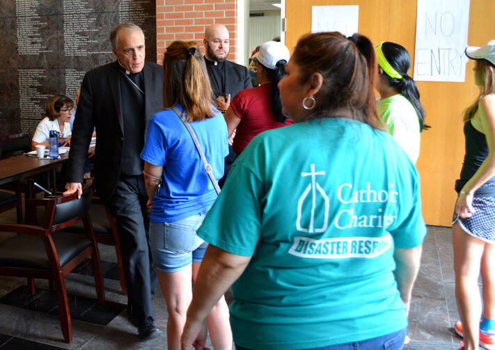 Cardinal Daniel N. DiNardo of Galveston-Houston, president of the U.S. Conference of Catholic Bishops, visits a Catholic Charities center in Houston, Texas, on Sept. 3. (CNS photo/courtesy Catholic Charities)