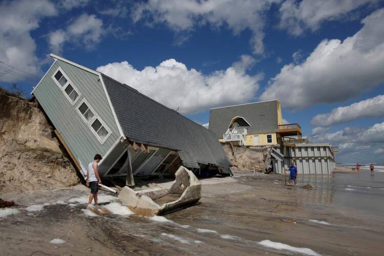 Residents look at a collapsed house on Sept. 12 after Hurricane Irma passed the area in Vilano Beach, Florida. (CNS photo/Chris Wattie, Reuters)