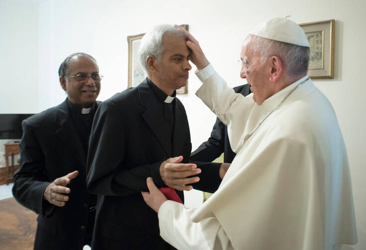 Salesian Father Tom Uzhunnalil, who was released on Sept. 12 after having been kidnapped 18 months ago in Yemen, is anointed by Pope Francis during a Sept. 13 meeting at the Vatican. (CNS photo/L'Osservatore Romano)
