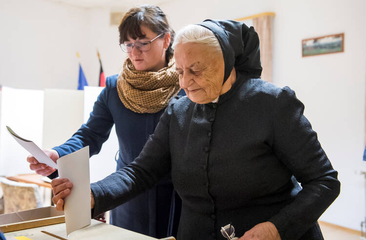 Women casts their votes in 2017 at a polling station in Crostwitz, Germany. (CNS photo/Matthias Rietschel, Reuters) )