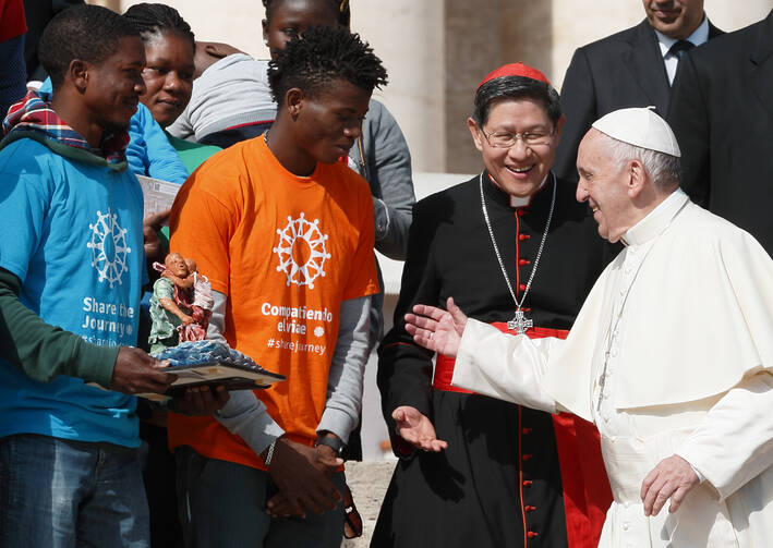 Pope Francis greets Cardinal Luis Antonio Tagle of Manila, Philippines, and representatives of the “Share the Journey” campaign by Caritas Internationalis in support of immigrants, at the Vatican on Sept. 27. (CNS photo/Paul Haring)