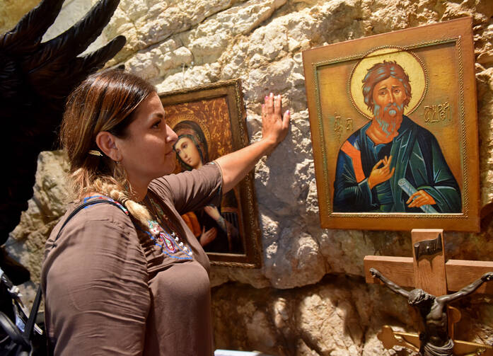 A woman prays on the Via Dolorosa in the Old City of Jerusalem on Sept. 11. The city is considered sacred to Christians, Jews and Muslims. (CNS photo/Debbie Hill)