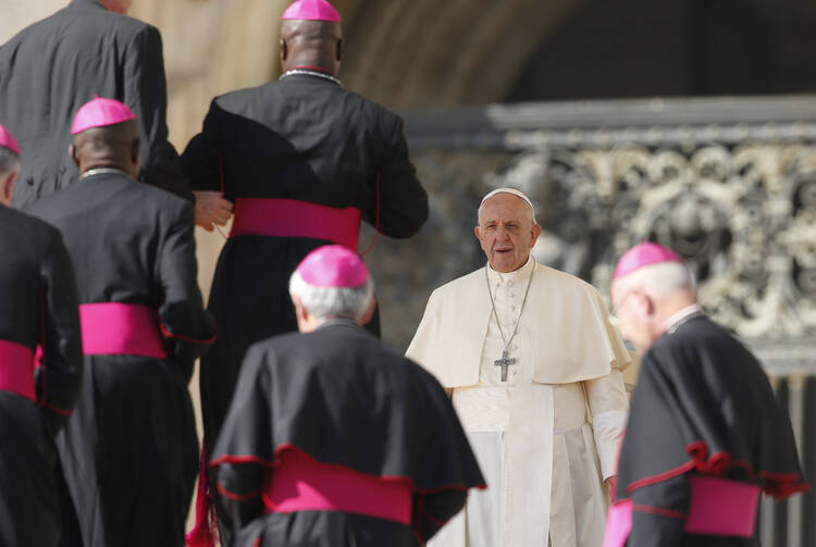 Pope Francis prepares to greet bishops during his general audience in St. Peter's Square at the Vatican Oct. 4. (CNS photo/Paul Haring)