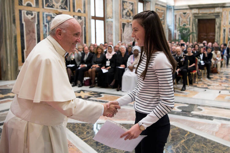 Pope Francis greets Muireann O'Carroll, 16, from Ireland during an audience with participants in an international congress on protecting children in a digital world, at the Vatican Oct. 6. The pope pledged "to work strenuously and with foresight for the protection of minors and their dignity." (CNS photo/L'Osservatore Romano) 