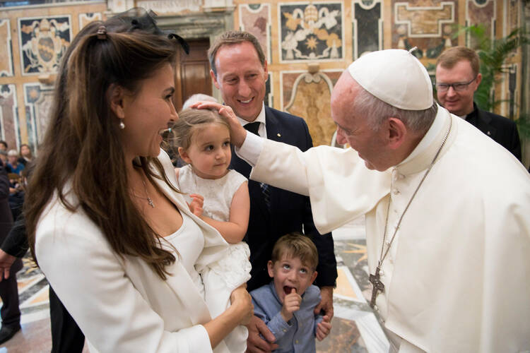 Pope Francis greets family members during an audience with participants in an international congress on protecting children in a digital world, at the Vatican Oct. 6. (CNS photo/L'Osservatore Romano)
