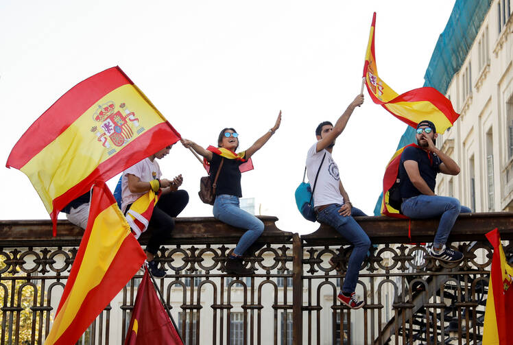 People wave Spanish flags during an Oct. 8 demonstration organized by the Catalan Civil Society organization in Barcelona, Spain. (CNS photo/Eric Gaillard, Reuters)