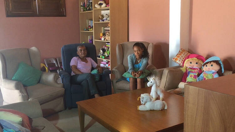 Gloria Gallardo and her granddaughter, Diana Diaz, 14, are seen in a still photo taken from video at the Nuestra Senora de la Esperanza house in Caracas, Venezuela. Diaz was born with both HIV and hepatitis B and has lived with diabetes since she was 9.(CNS photo/Cody Weddle)