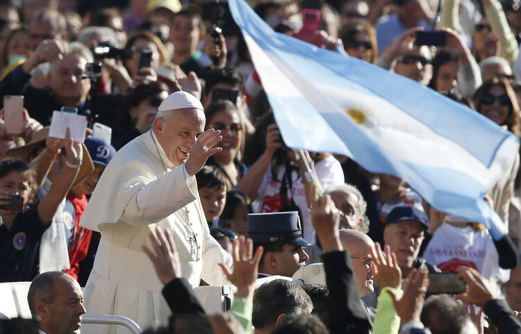 Argentina's flag is seen as Pope Francis greets the crowd during his general audience in St. Peter's Square at the Vatican on Oct. 11. (CNS photo/Paul Haring)