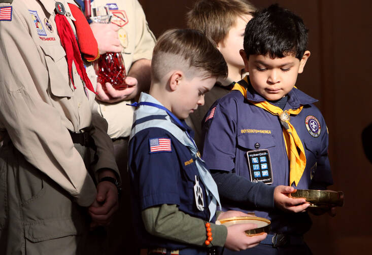Cub Scouts participate in the presentation of the gifts during a Mass marking Scout Sunday at St. Joseph Church in Kings Park, N.Y., Feb. 5. The Boy Scouts of America's board of directors unanimously agreed Oct. 11 to allow girls into the Cub Scout program next year and let older girls become Eagle Scouts. (CNS photo/Gregory A. Shemitz)