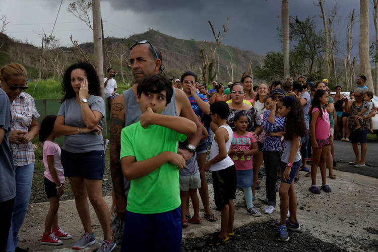 Residents wait for soldiers in helicopters to deliver food and water Oct. 13 during recovery efforts following Hurricane Maria in San Lorenzo, Puerto Rico. (CNS photo/Lucas Jackson, Reuters)