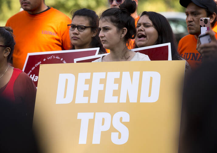 A woman holds a sign showing her support for Temporary Protected Status, or TPS, during a rally near the U.S. Capitol in Washington on Sept. 26. Bishop Joe S. Vasquez of Austin, Texas, chairman of the U.S. bishops' migration committee, told the U.S. government on Oct. 17 that current TPS recipients from El Salvador and Honduras "cannot return to safely to their home country at this time" and urged their TPS status be extended. (CNS photo/Tyler Orsburn)