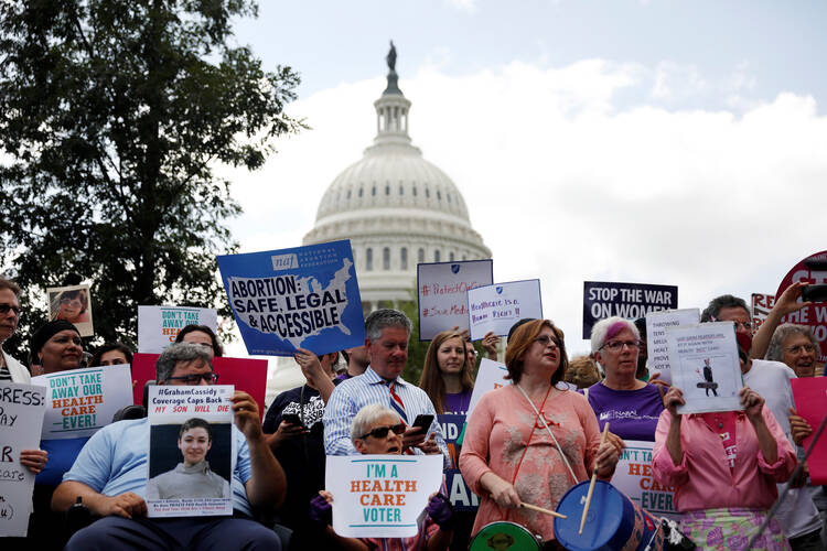Activists participate in a rally in late September to protect the Affordable Care Act outside the U.S. Capitol in Washington. (CNS photo/Aaron P. Bernstein, Reuters)