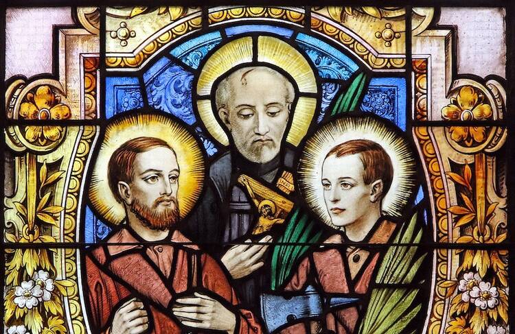 Sts. Jean de Lalande, Isaac Jogues and Rene Goupil, who were among the 17th-century French Jesuit missionaries martyred in North America, are depicted in a stained-glass window at the Cathedral-Basilica of Notre-Dame of Quebec in Quebec City. (CNS photo/Gregory A. Shemitz)