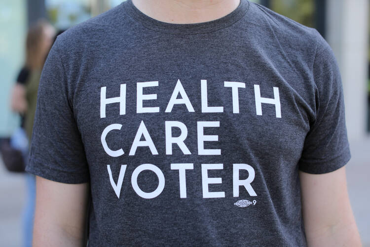 A protester wears a T-shirt at an Oct. 12 SoCal Health Care Coalition protest at the University of California San Diego in La Jolla, Calif. (CNS photo/Mike Blake, Reuters) 