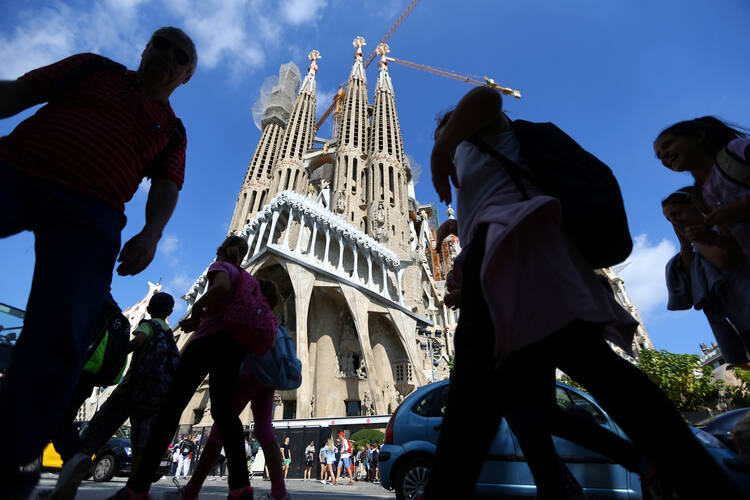 People walk near the Sagrada Familia basilica in Barcelona, Spain, Oct. 11. Ten days later, Cardinal Angelo Amato, prefect of the Vatican's Congregation for Saints' Causes, beatified 109 Spanish Claretian missionaries killed during their country's 1936-39 civil war. (CNS photo/Ivan Alvarado, Reuters)