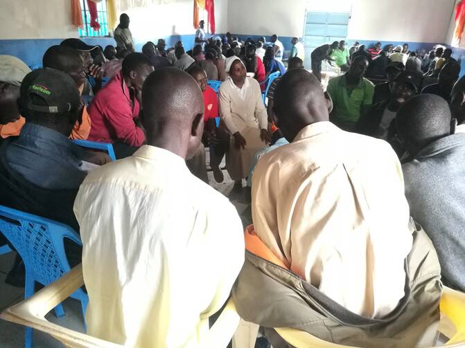  Sister Josephine Muthoni Kwenga listens to residents of Nairobi's Kibera slum ask questions about the Kenyan voting process during a voter education forum Oct. 13. (CNS photo/Lilian Muendo courtesy Global Sisters Report) 