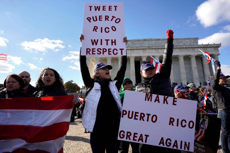 Members of the Hispanic Federation participate in a Unity March in November 2017 in front of the Lincoln Memorial in Washington to highlight the ongoing humanitarian and natural disaster crisis in Puerto Rico. (CNS photo/Yuri Gripas, Reuters)