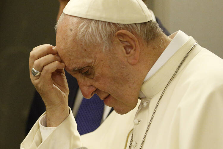 Pope Francis pauses as he answers questions from journalists aboard his flight from Dhaka, Bangladesh, to Rome Dec. 2. (CNS photo/Paul Haring)