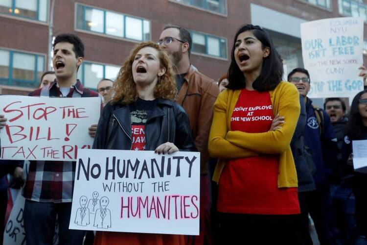 Graduate students rally against the proposed federal tax reform bill Nov. 29 in the Manhattan borough of New York City. Congress must "fix the fundamental flaws" in both the Senate and House versions of the tax bill as lawmakers try to reach an agreement on a final bill, said the chairman of the U.S. bishops' domestic policy committee. (CNS photo/Shannon Stapleton, Reuters)