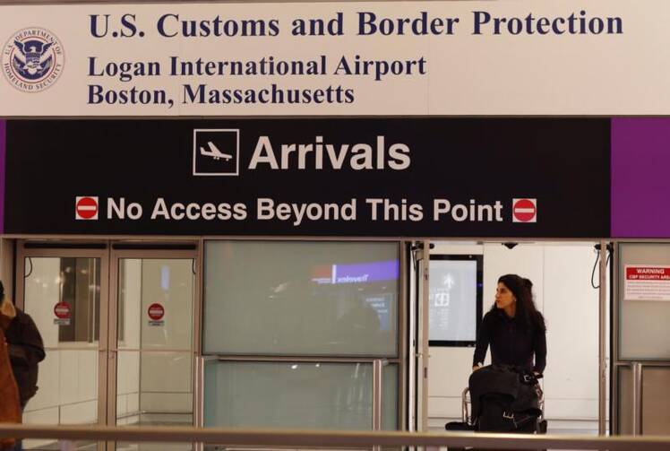 A passenger arrives through the U.S. Customs gate Dec. 4 at Logan International Airport in Boston. The Supreme Court will allow the latest version of President Donald Trump's travel ban to take effect while the legal fight over it winds through the lower courts. (CNS photo/CJ Gunther, EPA)