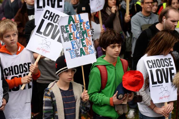 Young demonstrators gather outside Parliament in London on Oct. 24 to call for more child refugees to be allowed asylum and safe passage to the United Kingdom. (CNS photo/Mary Turner, Reuters)