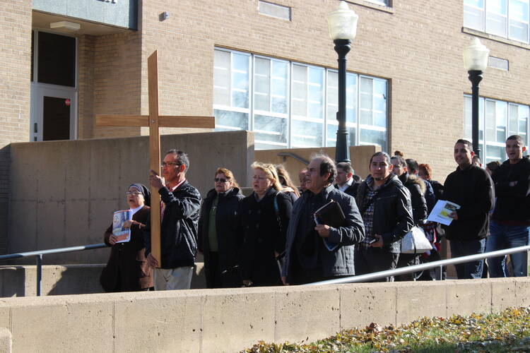 Participants in the Omaha, Neb., archdiocesan encuentro process Nov. 18 outside St. Cecilia Cathedral in Omaha with the Encuentro Cross. Some 60 parish leaders and representatives of the Latino community gathered for the archdiocesan encuentro, which is part of the preparations underway for the U.S. Catholic Church's Fifth National Encuentro, or V Encuentro, to be held in 2018 in Texas. (CNS photo/Lisa Maxson, for the Catholic Voice)