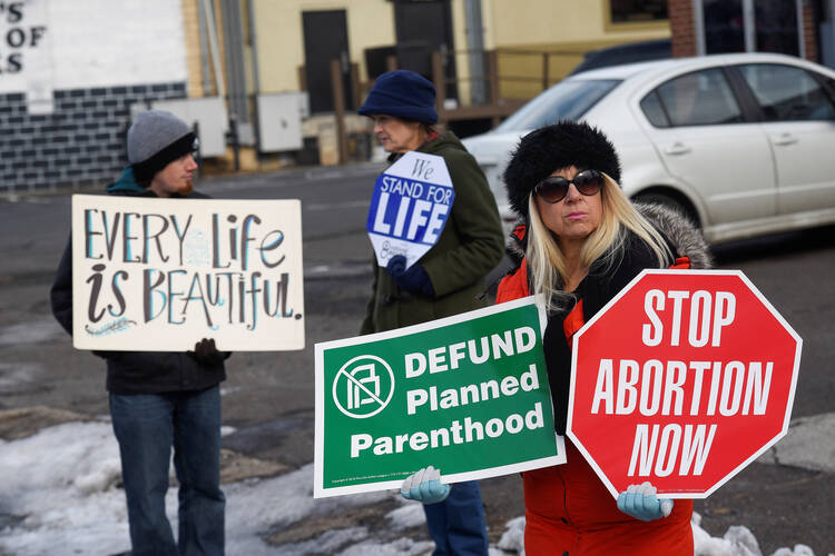 Pro-life supporters protest in front of a Planned Parenthood center in early February in Philadelphia. Pennsylvania Gov. Tom Wolf vetoed pro-life legislation that "would have strengthened" the state's Abortion Control Act "by banning the cruel and brutal practice of dismemberment abortions," said the state Catholic conference. (CNS photo/Charles Mostoller, Reuters