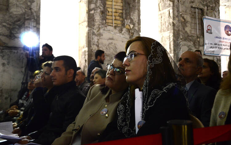 Chaldean Christians in Mosul, Iraq, attend Christmas Mass at St. Paul Cathedral Dec. 24. (CNS photo/Amar Salih, EPA)