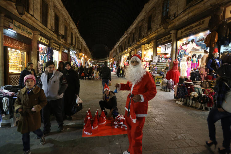 A man dressed as Santa is seen in Damascus, Syria, Dec. 24. Catholic patriarchs of the Middle East called for peace, security, prayer and solidarity at Christmastime.