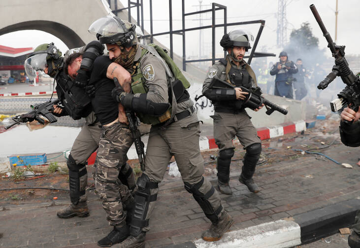 Israeli border police arrest a Palestinian man near Ramallah, West Bank, during a late-December protest against U.S. President Donald Trump's decision to recognize Jerusalem as the capital of Israel. (CNS photo/Goran Tomasevic, Reuters)