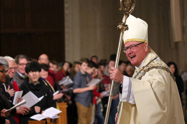 New York Cardinal Timothy M. Dolan, chairman of the U.S. bishops' Committee on Pro-Life Activities, smiles as he processes from the sanctuary after celebrating the opening Mass of the National Prayer Vigil for Life at the Basilica of the National Shrine of the Immaculate Conception in Washington on Jan. 18. The all-night vigil is held before the annual March for Life, which this year marked the 45th anniversary of the Supreme Court's Roe v. Wade decision that legalized abortion across the nation. (CNS photo