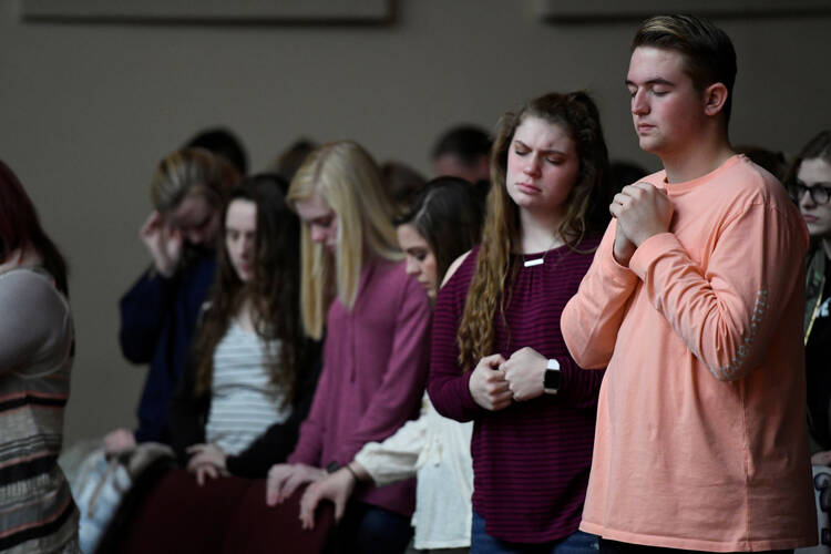 Students attend a prayer vigil Jan. 23 at a church in Marion, Ky., after a 15-year-old boy opened fire with a handgun that day at Marshall County High School. Cardinal Daniel N. DiNardo of Galveston-Houston, president of the U.S. Conference of Catholic Bishops, called for prayers for the victims killed and injured in a pair of school shootings in Kentucky and Italy High School in Texas Jan. 22. (CNS photo/Harrison McClary, Reuters)