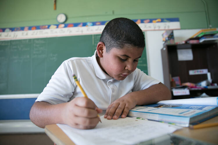 A student completes assignments in class in 2017 at St. Joseph Mission School in rural San Fidel, N.M. The school's student body is 90 percent Native American and 10 percent Hispanic. (CNS photo/Rich Kalonick, Catholic Extension)