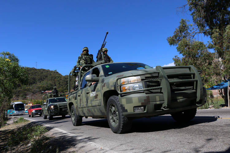 Armed members of the Mexican Army and state police arrive in Chilapa in 2016 to participate in an operation against organized crime. (CNS photo/Francisca Meza, EPA)