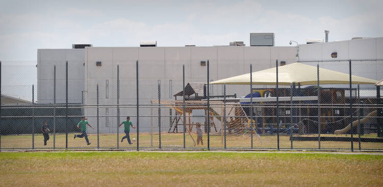 Children play in a double-fenced playground area outside the T. Don Hutto "Family Residential Facility" in Taylor, Texas. Migration is not a crime and vulnerable migrant and refugee children should not be detained as if they were criminals, speakers said at a U.N. program Feb 21 in New York City. (CNS photo/Bahram Mark Sobhani)