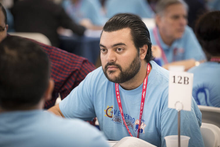 Mark Gomez, a lay leader of Encuentros Juveniles in the Miami Archdiocese, listens during the Encuentro gathering on Feb. 23 in that city. (CNS photo/Tom Tracy)