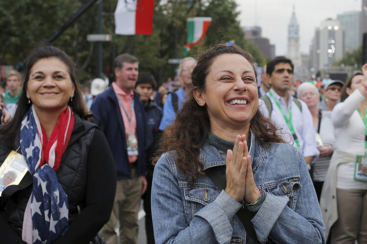 A woman reacts to Pope Francis' final words during the closing Mass of the World Meeting of Families in Philadelphia in this 2015 file photo. The pope will attend the next W.M.F., to be held Aug. 21-26 in Dublin. (CNS photo/Brian Snyder, Reuters) 
