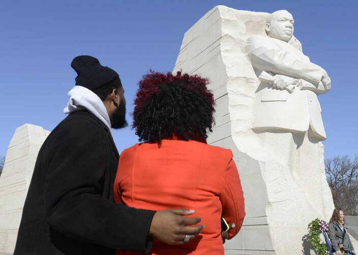 Aaron Brown of Houston and Arielle Phillips of Charlotte, N.C., pause to view a 30-foot sculpture of the Rev. Martin Luther King Jr. in Washington Jan. 19. (CNS photo/Mike Theiler, Reuters)