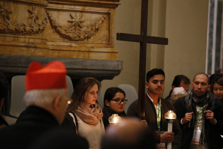 Youths attending a pre-synod meeting participate in the Way of the Cross at the Basilica of St. John Lateran in Rome on March 23. (CNS photo/Paul Haring)
