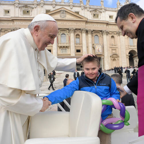 Pope Francis greets Peter Lombardi, 12, of Columbus, Ohio, after the boy rode in the popemobile during his general audience in St. Peter's Square at the Vatican March 28. Receiving a kiss from the pope was a wish come true for Peter, who has Down syndrome and has survived leukemia. (CNS photo/Vatican Media)