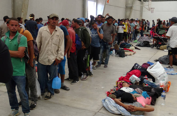 Central American migrants gather before continuing their journey on March 31 in Ixtepec, Oaxaca, Mexico. (CNS photo/Jose Jesus Cortes, Reuters) 